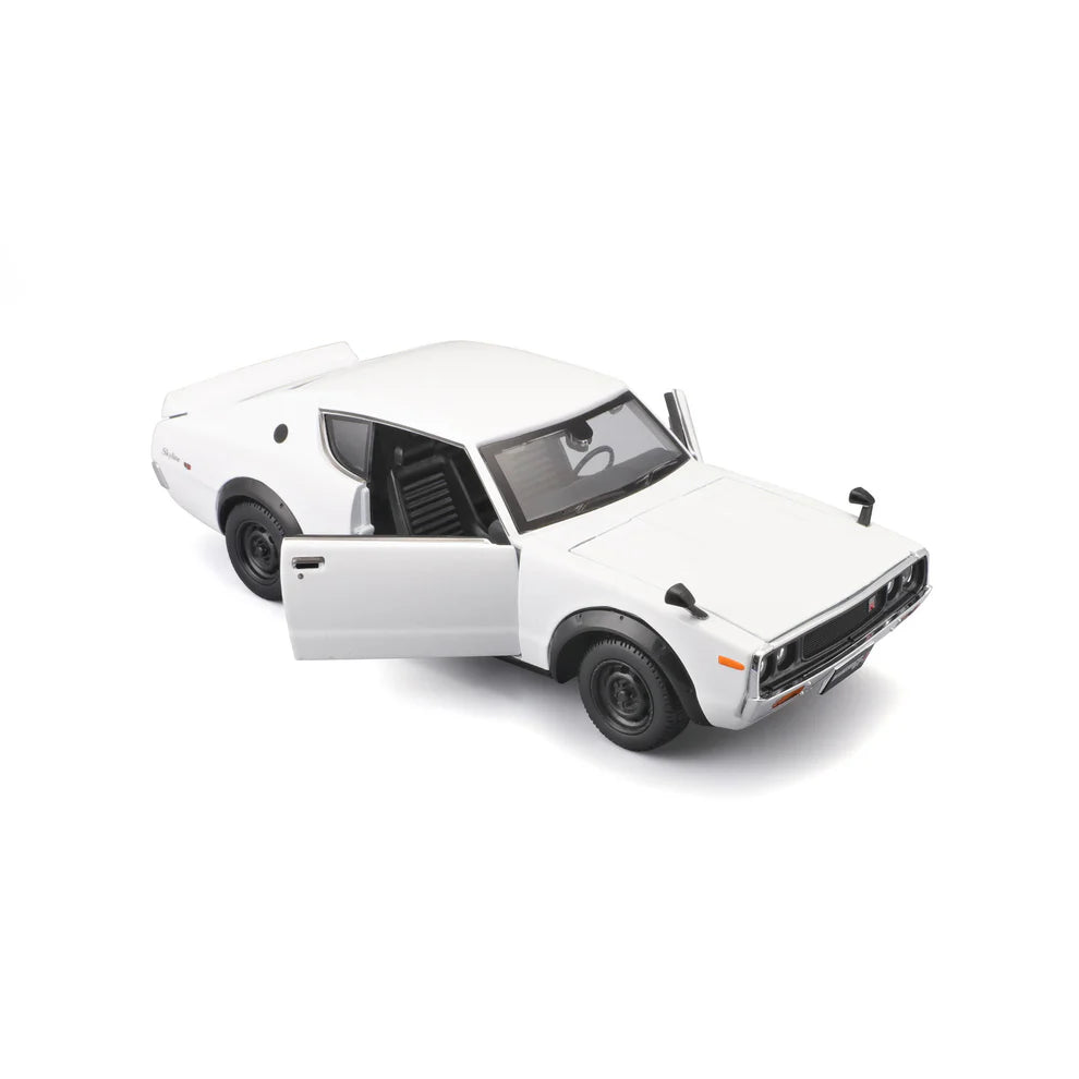 White 1:24 Nissan Skyline 2000GT-R model in angled front view with the driver door open, showing the black interior and front grille badge