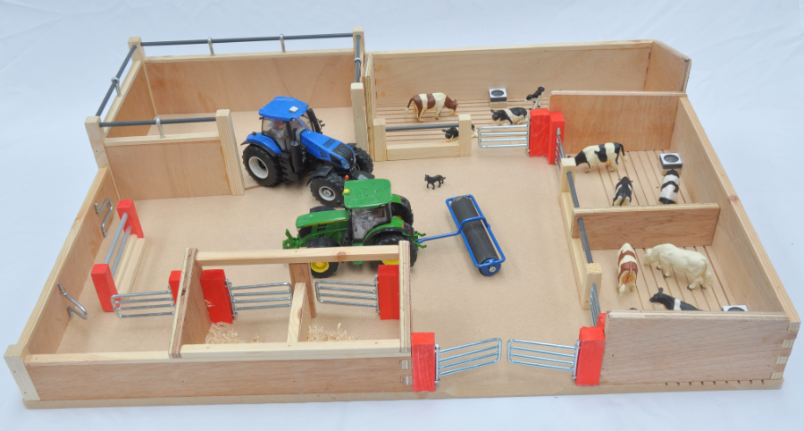 Wooden farm model with toy tractors and animals on a light blue background