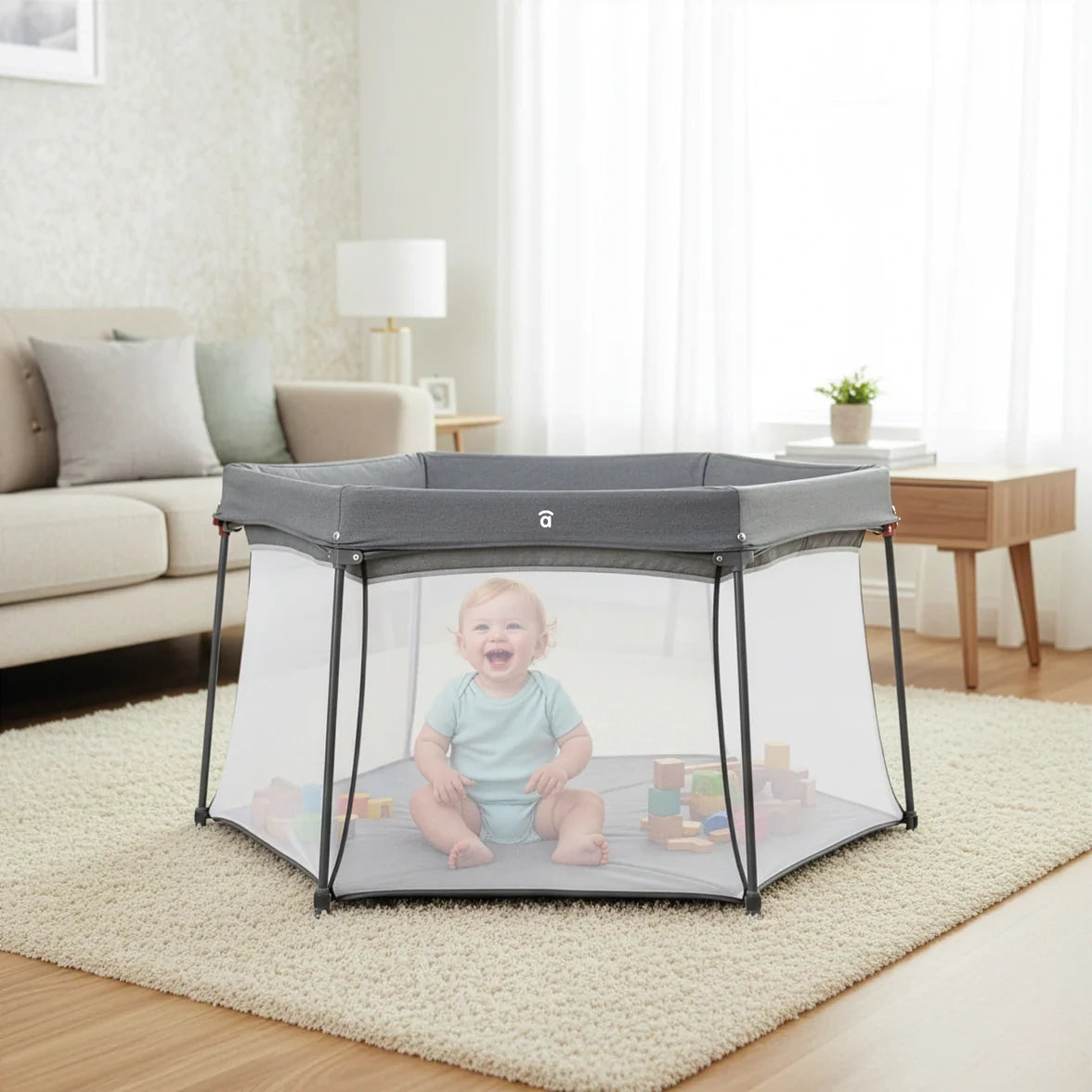 Asalvo Luxemburgo Playpen shown in a living room with baby sitting inside