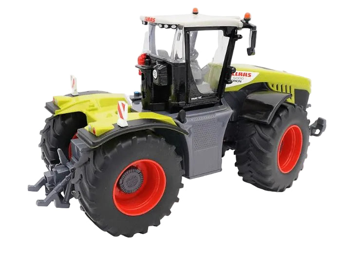 Britains Claas Xerion 5000 Tractor shown at a rear angled view with green body colour and large front and back tyres on a white background.