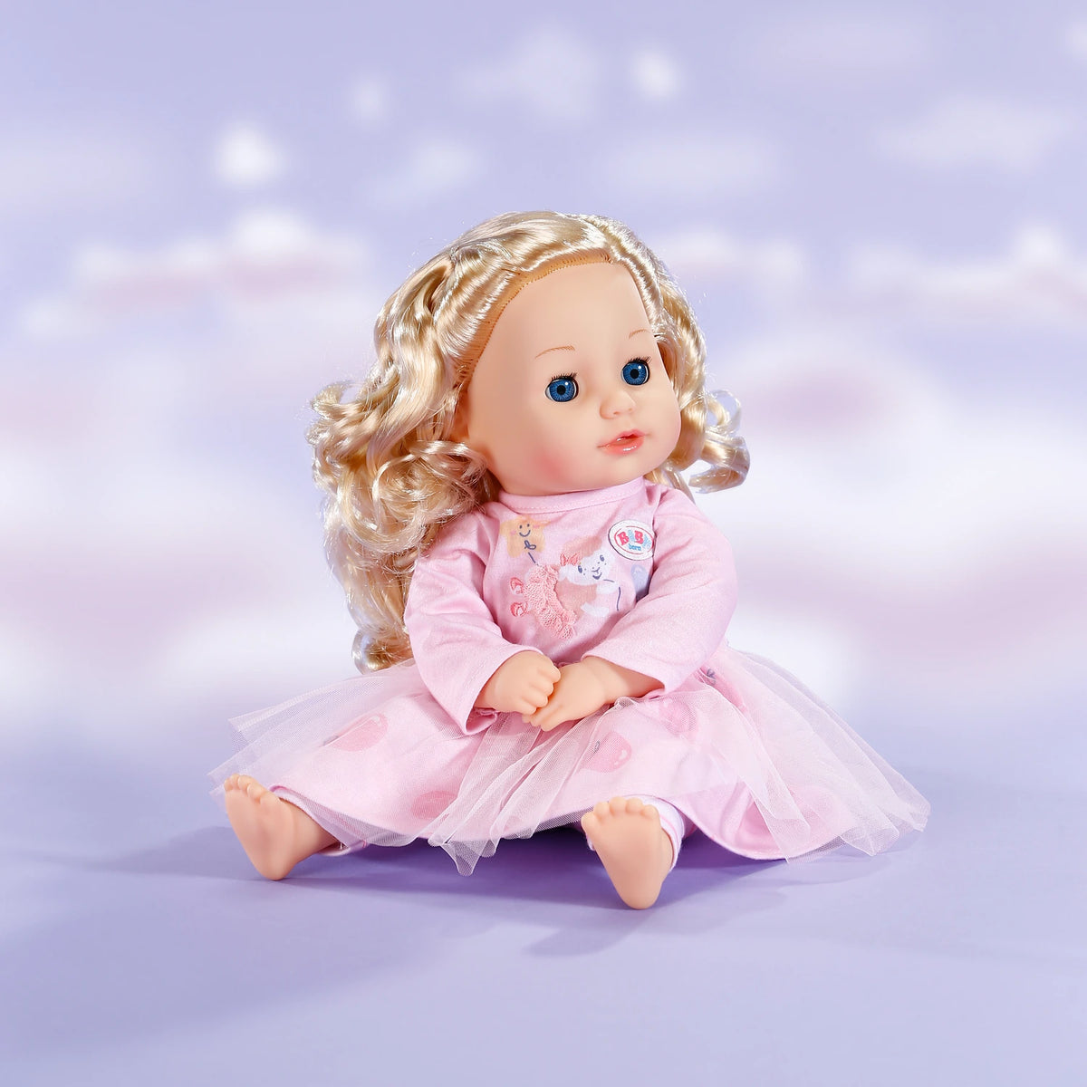 Baby Born Dress Rose outfit worn by seated blonde doll