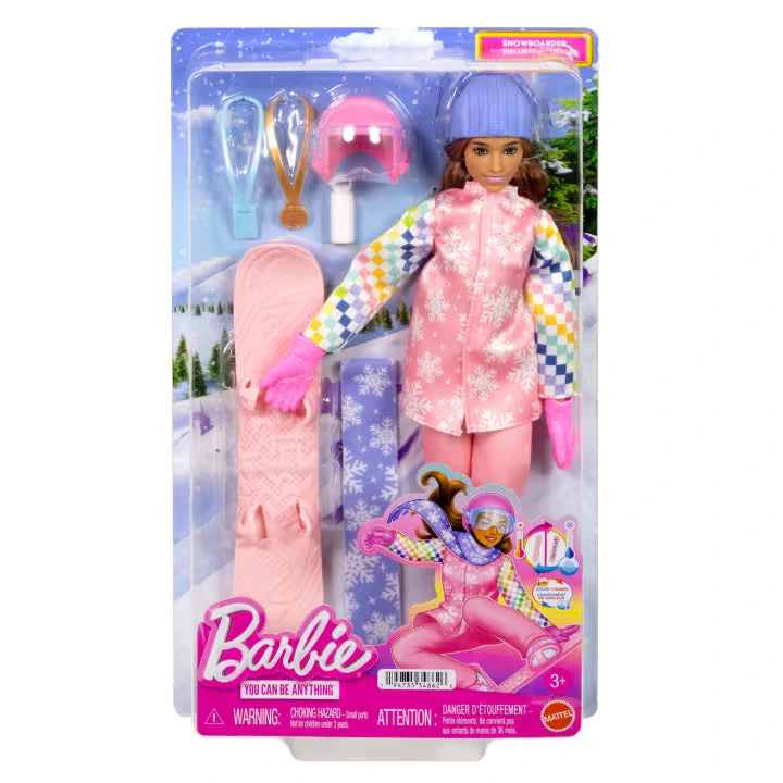 Barbie Careers Snowboarder Doll in retail packaging, wearing a blue knitted hat, pink snowflake jacket and matching trousers, with a pink snowboard, helmet, gold medal and blue scarf displayed inside.