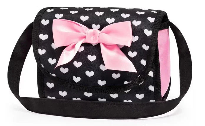 Matching black and pink heart patterned doll bag with pink bow displayed alone