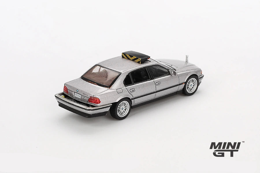 Mini GT James Bond Tomorrow Never Dies BMW 750IL silver LHD model viewed from the rear left showing the boot, rear lights, silver wheels and black roof unit