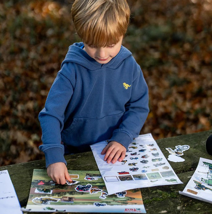 Child using Tractor Ted sticker pack on a farm-themed sheet - Ireland
