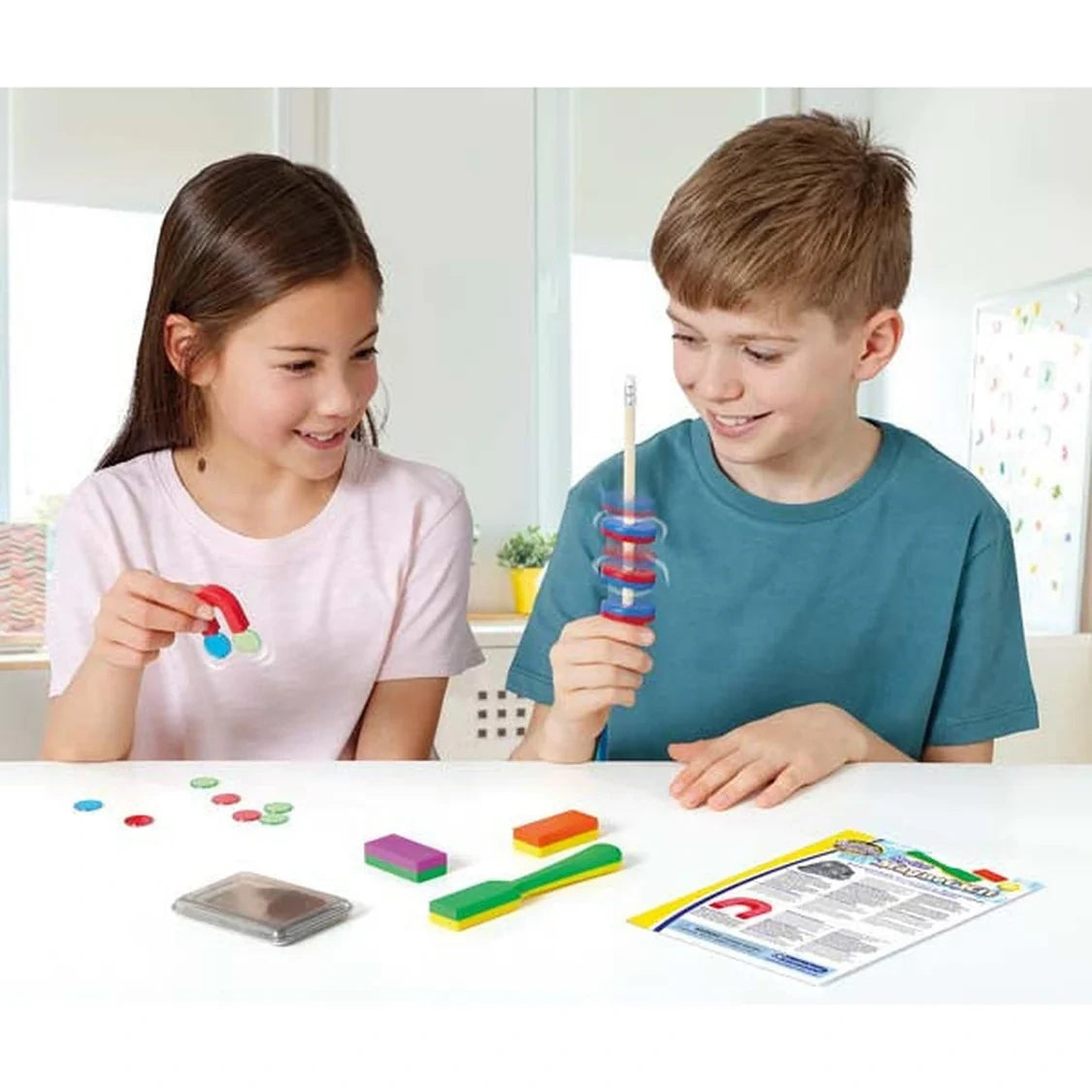 Brainstorm My First Magnet Kit being used by two children with ring magnets, horseshoe magnet and other kit pieces on the table