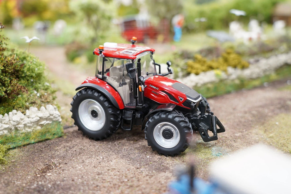 Britains Case Farmall 120 C farm toy tractor shown from the front right on a model farm track