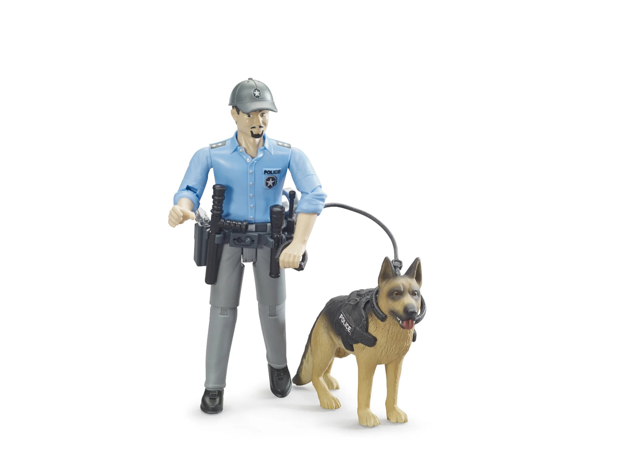 Bruder bworld police officer figure wearing a light blue shirt, grey trousers and grey cap, holding a black lead attached to a police dog wearing a black harness marked POLICE