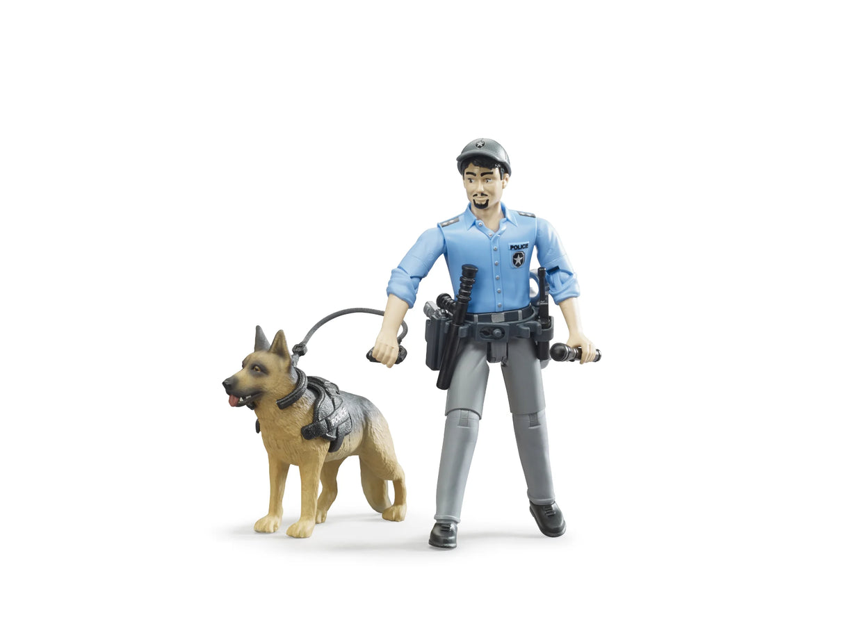 Bruder bworld police officer figure in a light blue shirt and grey trousers holding a black baton and lead, standing beside a police dog wearing a black harness marked POLICE