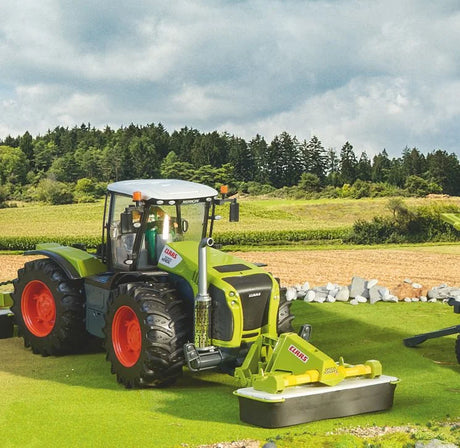 Bruder Claas Disco 3050 FC Plus mower attached to Claas tractor in realistic model farm field scene
