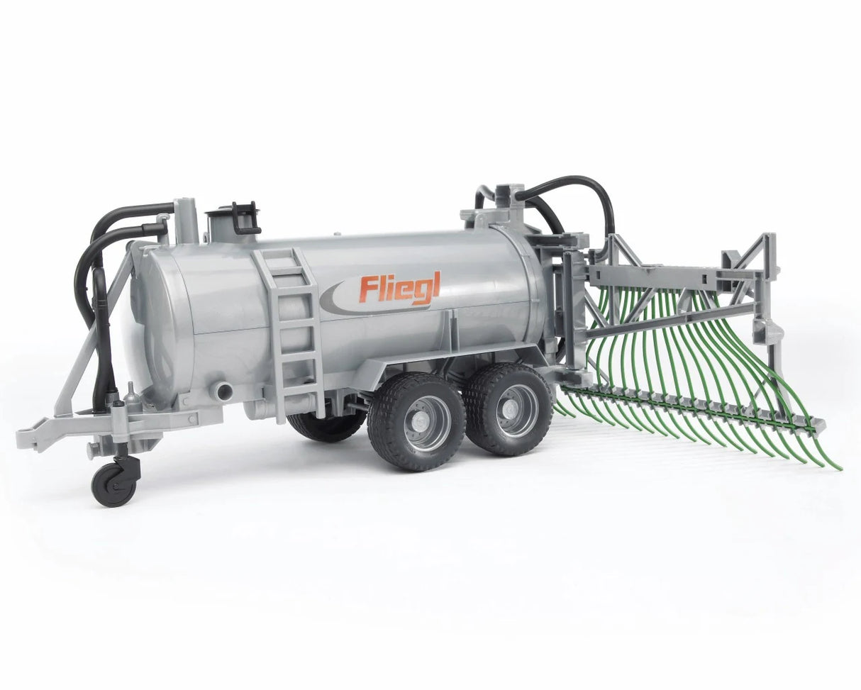 Front side view of silver Fliegl farm toy barrel trailer with green spread tubes