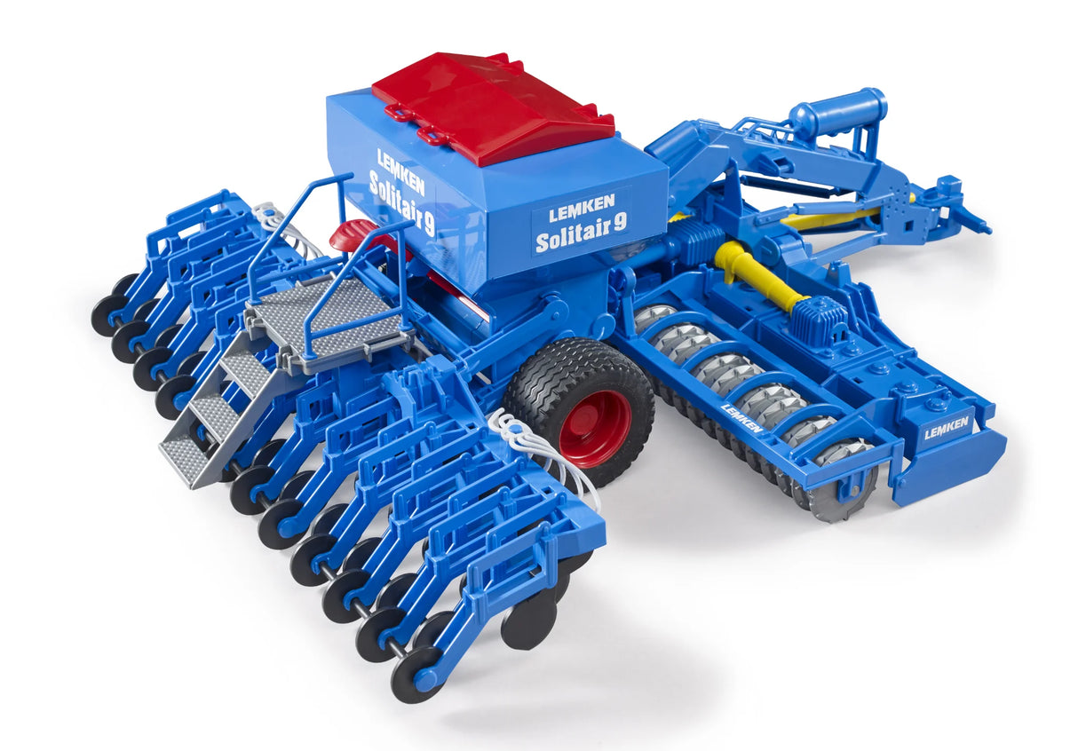 A close view of a blue Lemken Solitair 9 toy seeding machine with multiple sowing arms and a red topped hopper.