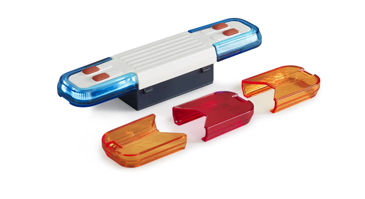 A close view of a toy light and sound module with a blue and white light bar and three coloured caps.
