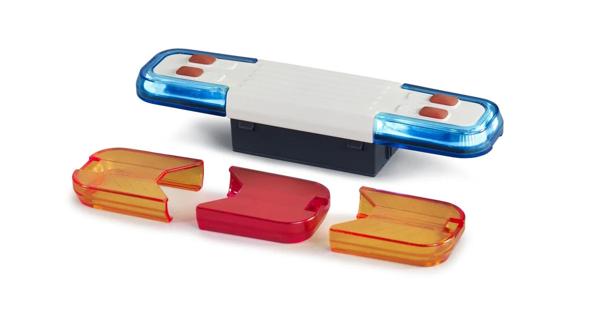 A toy light and sound module with a blue and white light bar and three coloured caps arranged beside it.