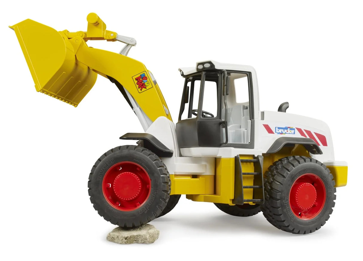 Bruder ROADMAX Wheel Loader lifting front wheel on rock with tilted bucket and realistic play detail