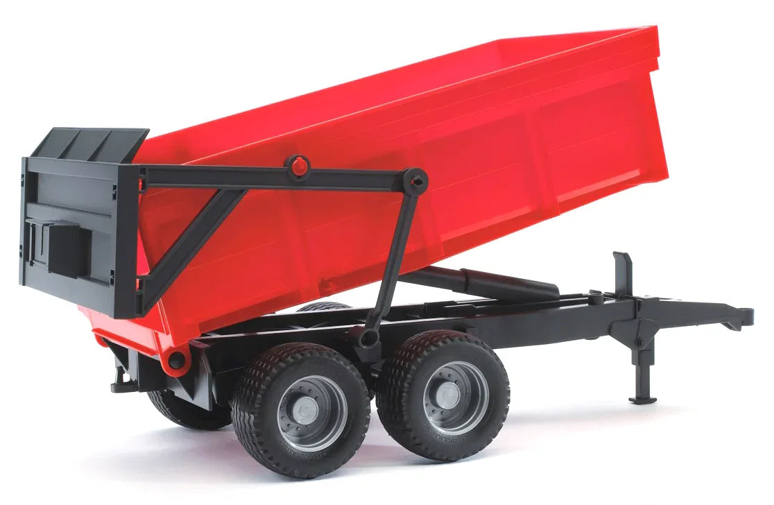 Red Bruder tipping trailer toy with a black frame and its trailer bed lifted upward