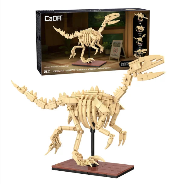 CaDA Dinosaur Fossils Velociraptor box displaying tan skeleton model and glow-in-the-dark feature label