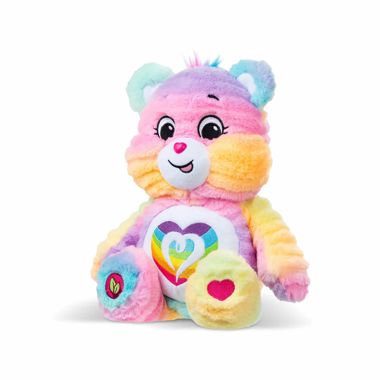 Angled view of Care Bears Color Splash Togetherness Bear highlighting soft rainbow tie-dye plush and heart badge in Ireland.