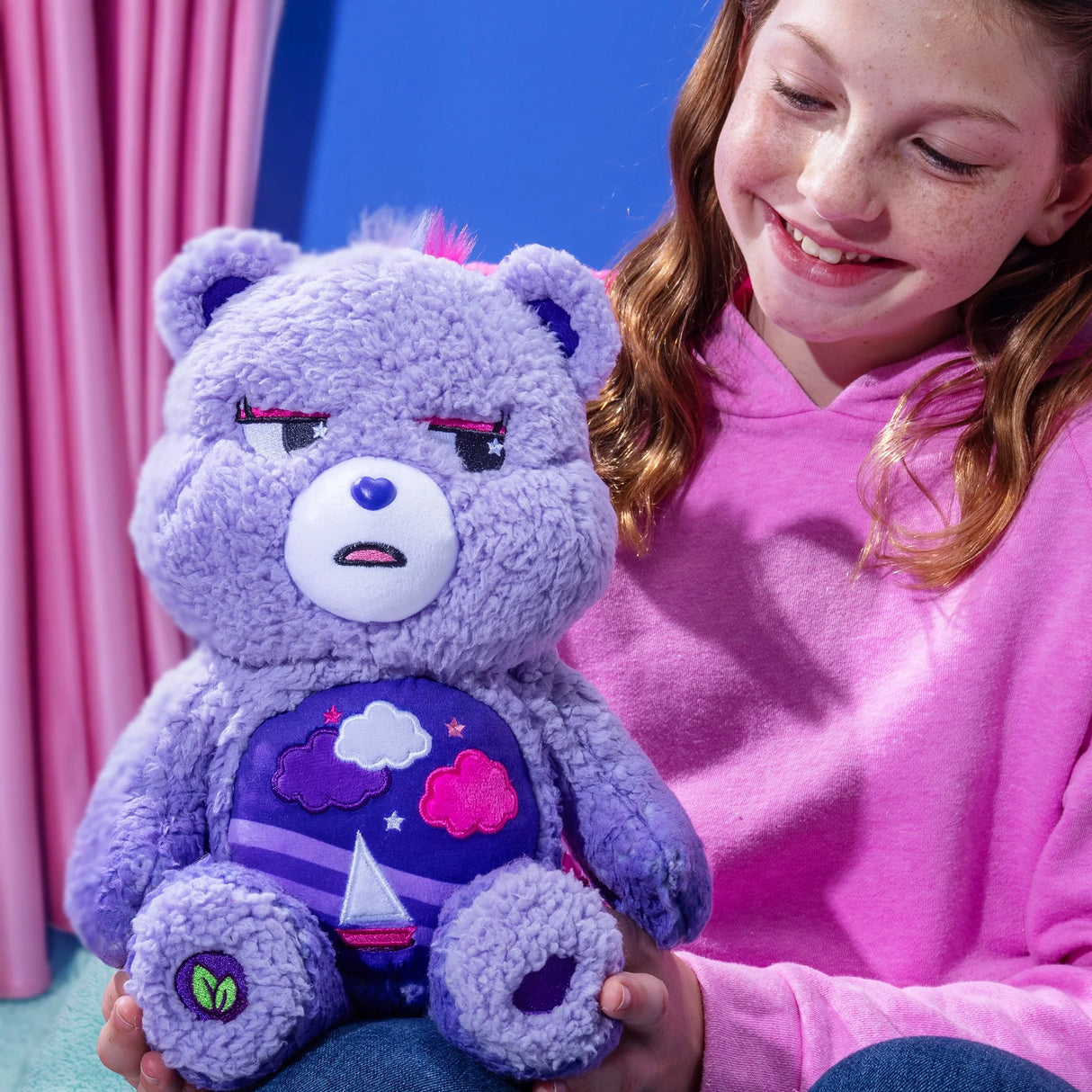 Child cuddling Care Bears Cozy Stormy Heart Bear plush showing soft sherpa texture and gentle design in Ireland.