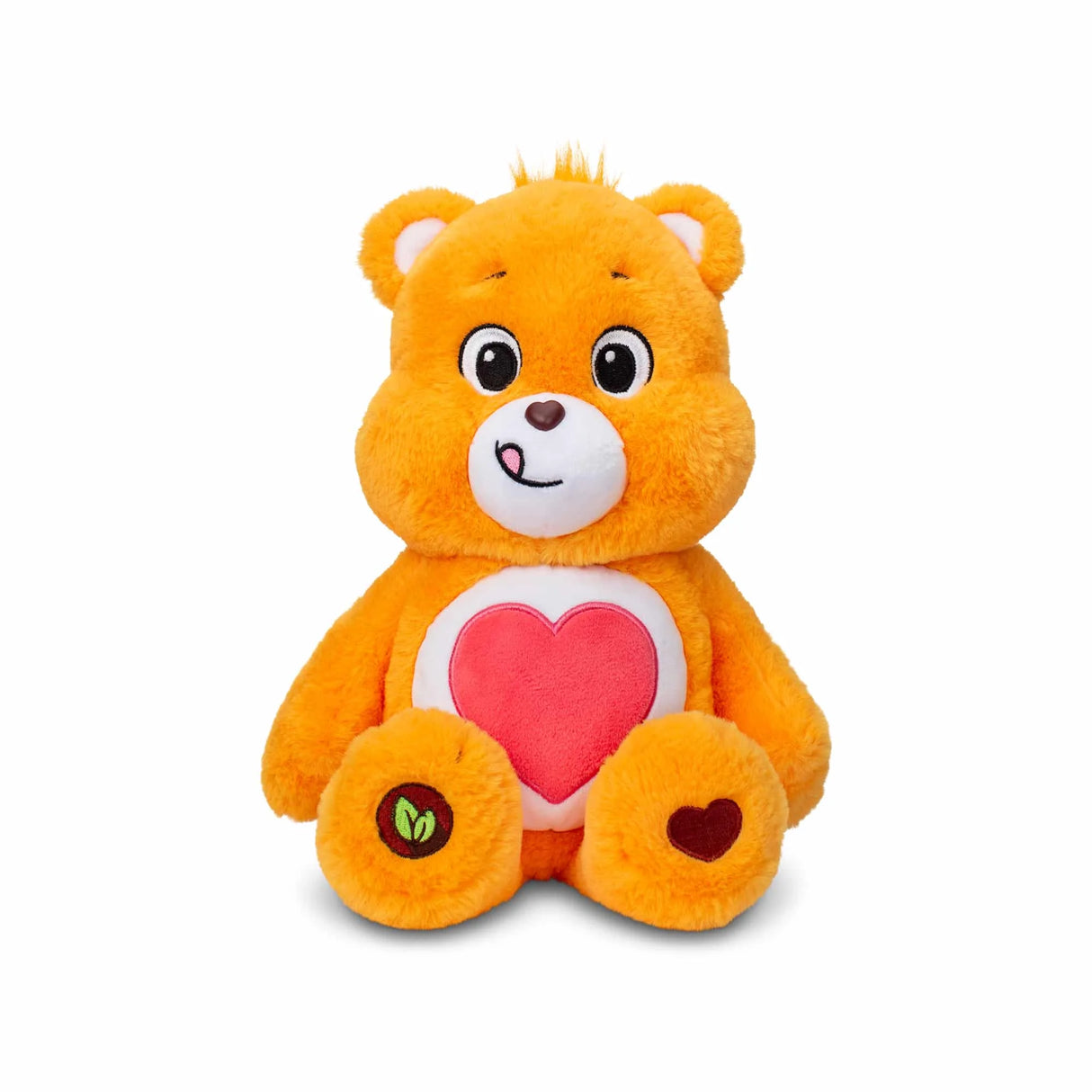 Front view of Care Bears Tenderheart Bear plush with bright orange fur and large red heart belly badge in Ireland.