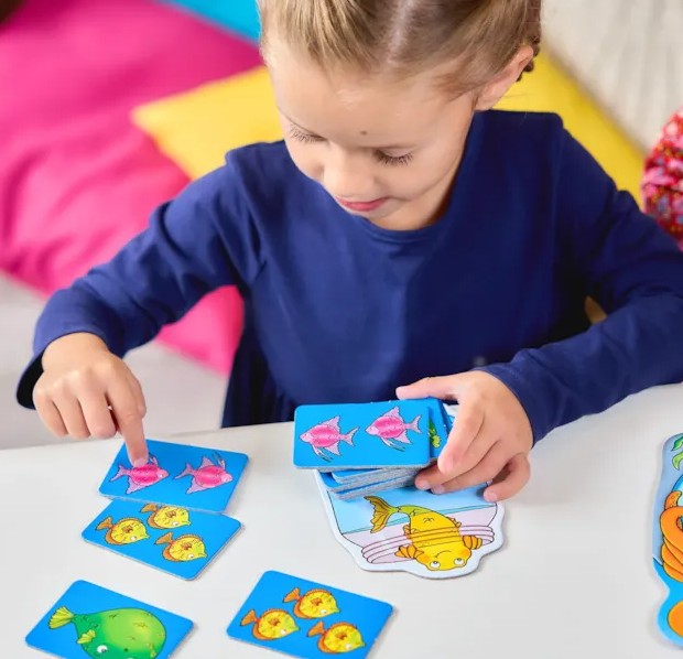 Child Playing Catch and Count Game with Fish Cards - Ireland