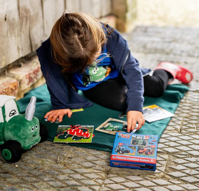 Child Playing with Tractor Ted Puzzle Set Outside in Ireland
