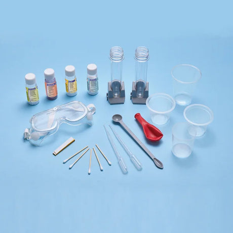 Chemistry set contents laid out including test tubes goggles pipettes and experiment accessories