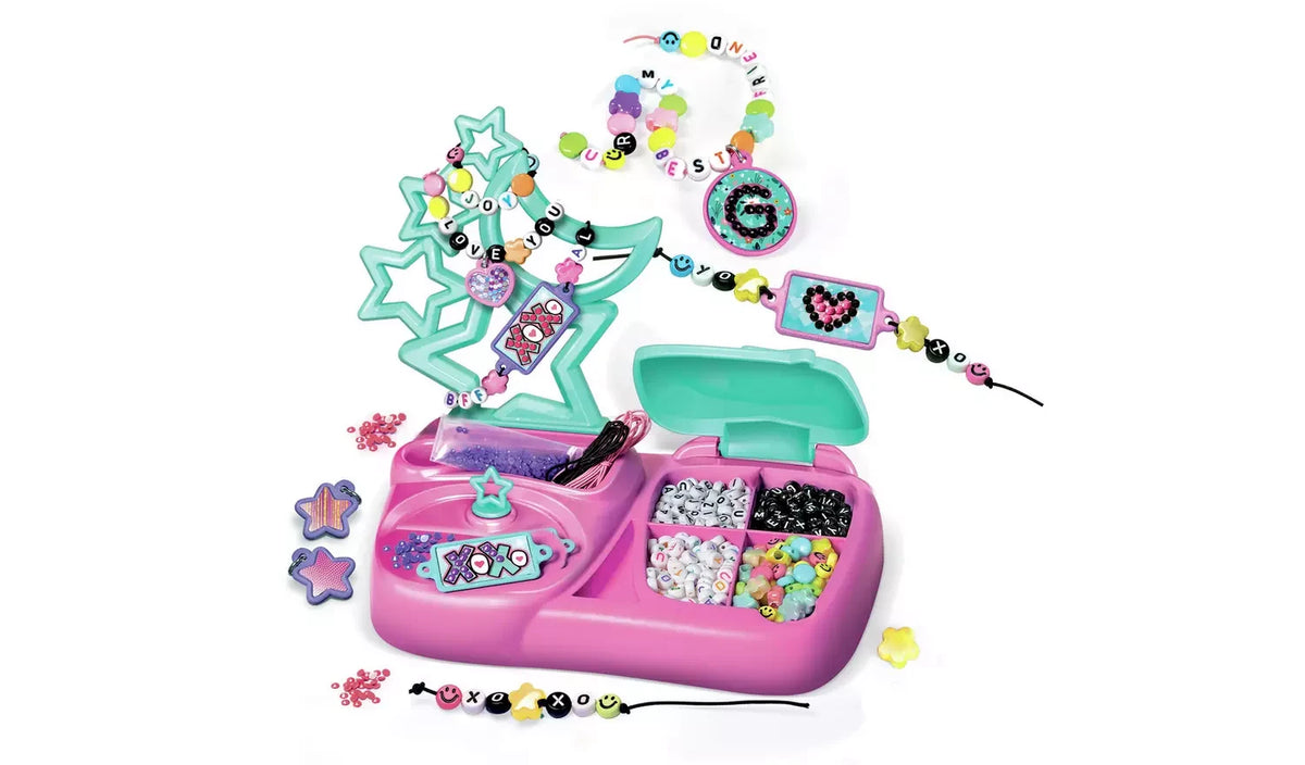 Crazy Chic Message Creations pink jewellery workstation with compartments of colourful and alphabet beads, mint green star-shaped holder, decorated bracelets, charms and cords arranged on a white background.