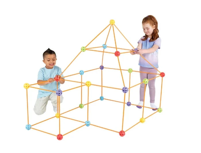 Two children assembling a house-shaped Crazy Forts structure using orange rods and red, yellow, blue, purple and green connector balls.