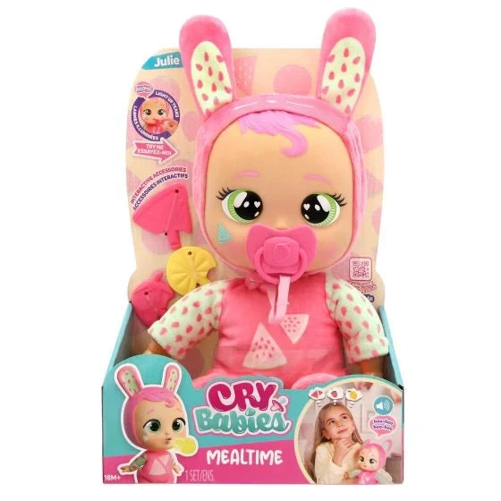 Cry Babies Meal Time Julie doll in retail packaging, wearing a pink bunny outfit with feeding accessories.