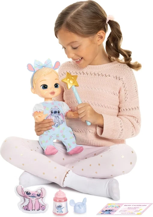 Child holding the gold star wand beside the Disney Darlings Stitch Blonde Doll with accessories below