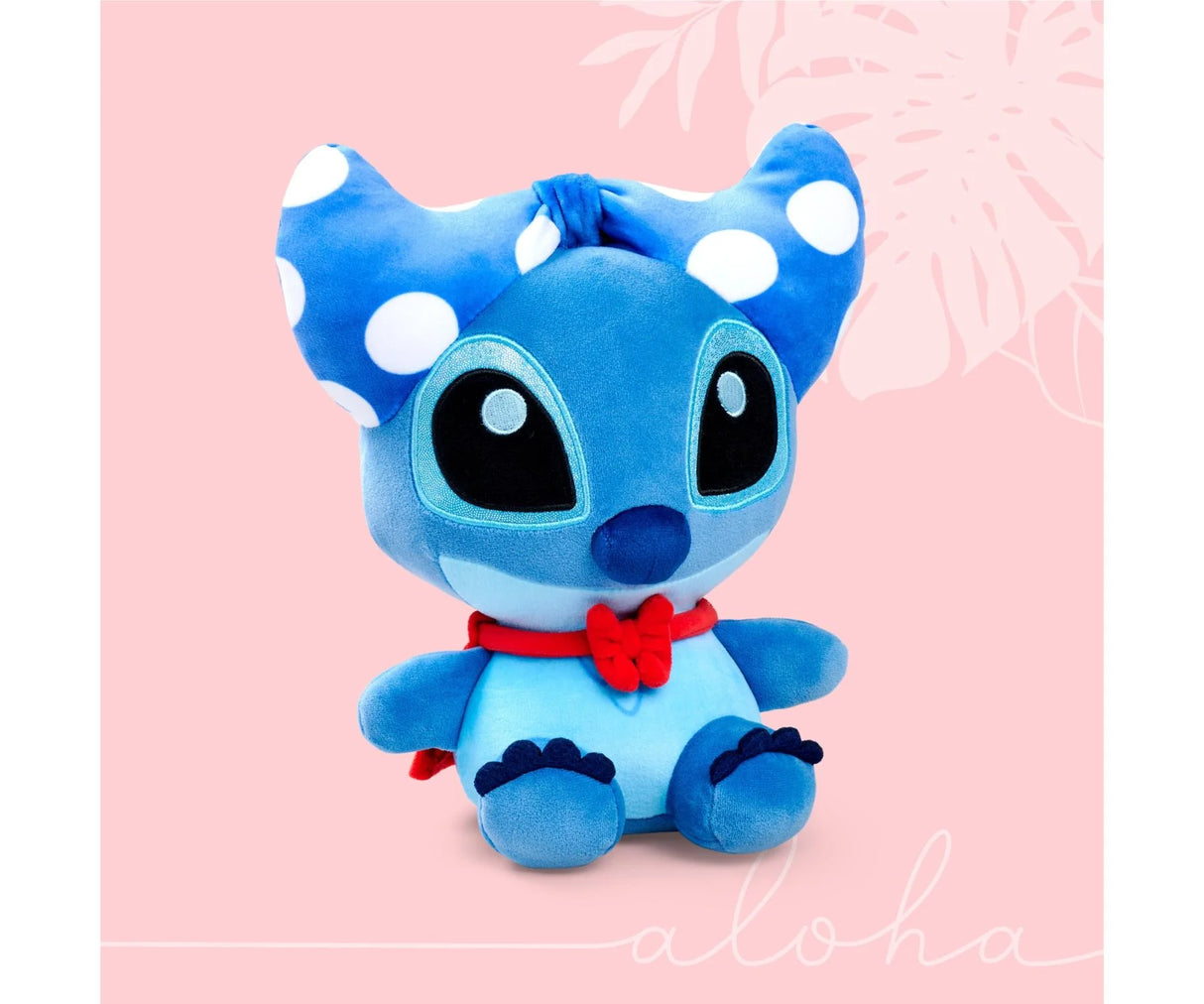 Front view of Disney Doorables Stitch 25 cm plush toy with blue fur, red scarf and white polka dot bow on pink background.