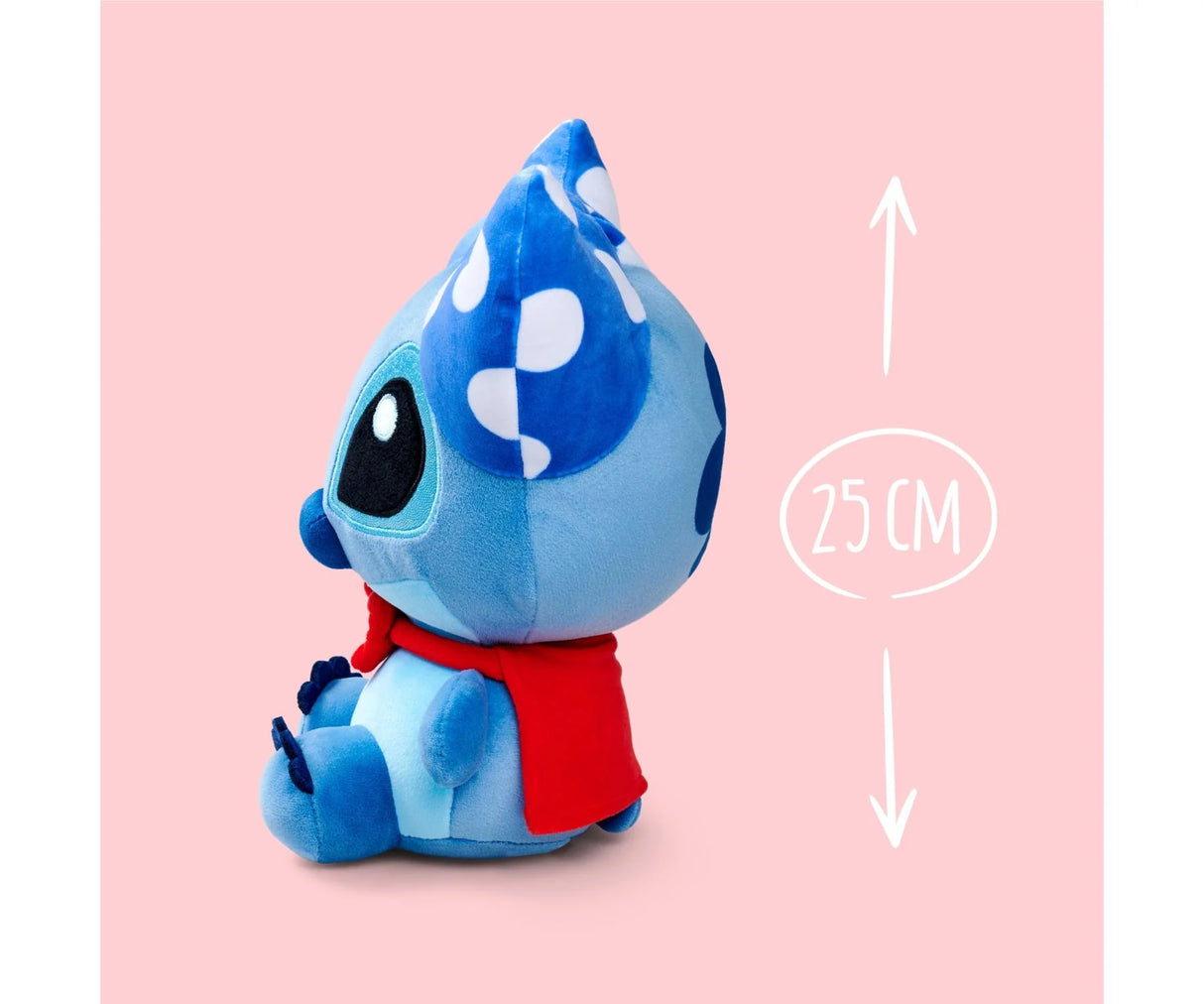 Side view of the Disney Doorables Stitch 25 cm plush toy showing blue fur, red scarf and spotted bow detail on pink backdrop.