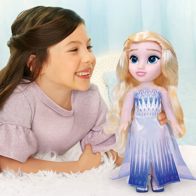 Child playing with Disney Frozen Elsa Toddler Doll dressed in blue gown with long blonde hair in Ireland.
