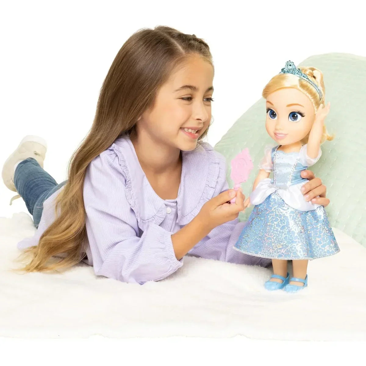 Child playing with Disney Princess Cinderella Toddler Doll dressed in glittering gown and tiara in Ireland.