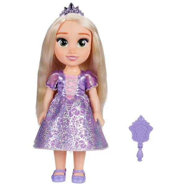 Child playing with Disney Rapunzel Toddler Doll wearing purple dress and tiara in Ireland.