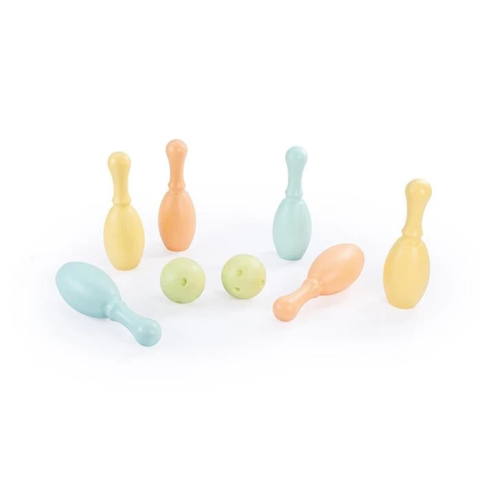 Pastel coloured bowling pins and balls arranged on a white background