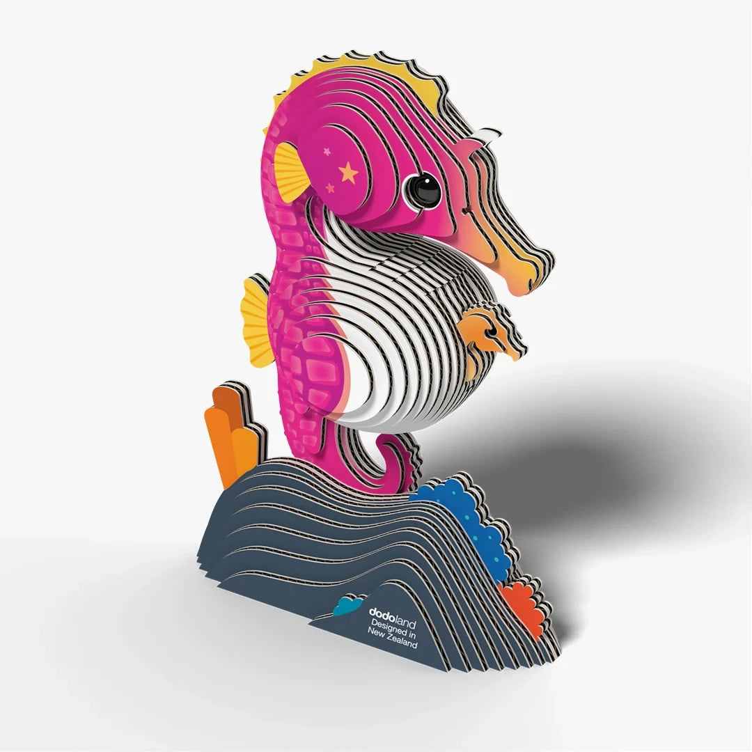 EUGY Seahorse 3D cardboard model viewed from the right with visible layered construction, yellow fins, baby seahorse and dark blue coral base