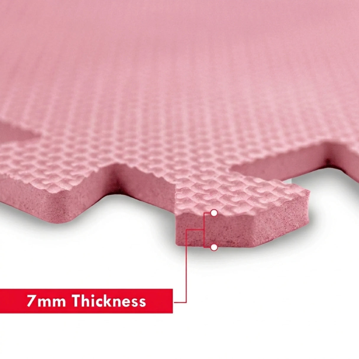 Close up of pink EVA foam play mat corner showing interlocking tab detail and 7mm thickness label graphic