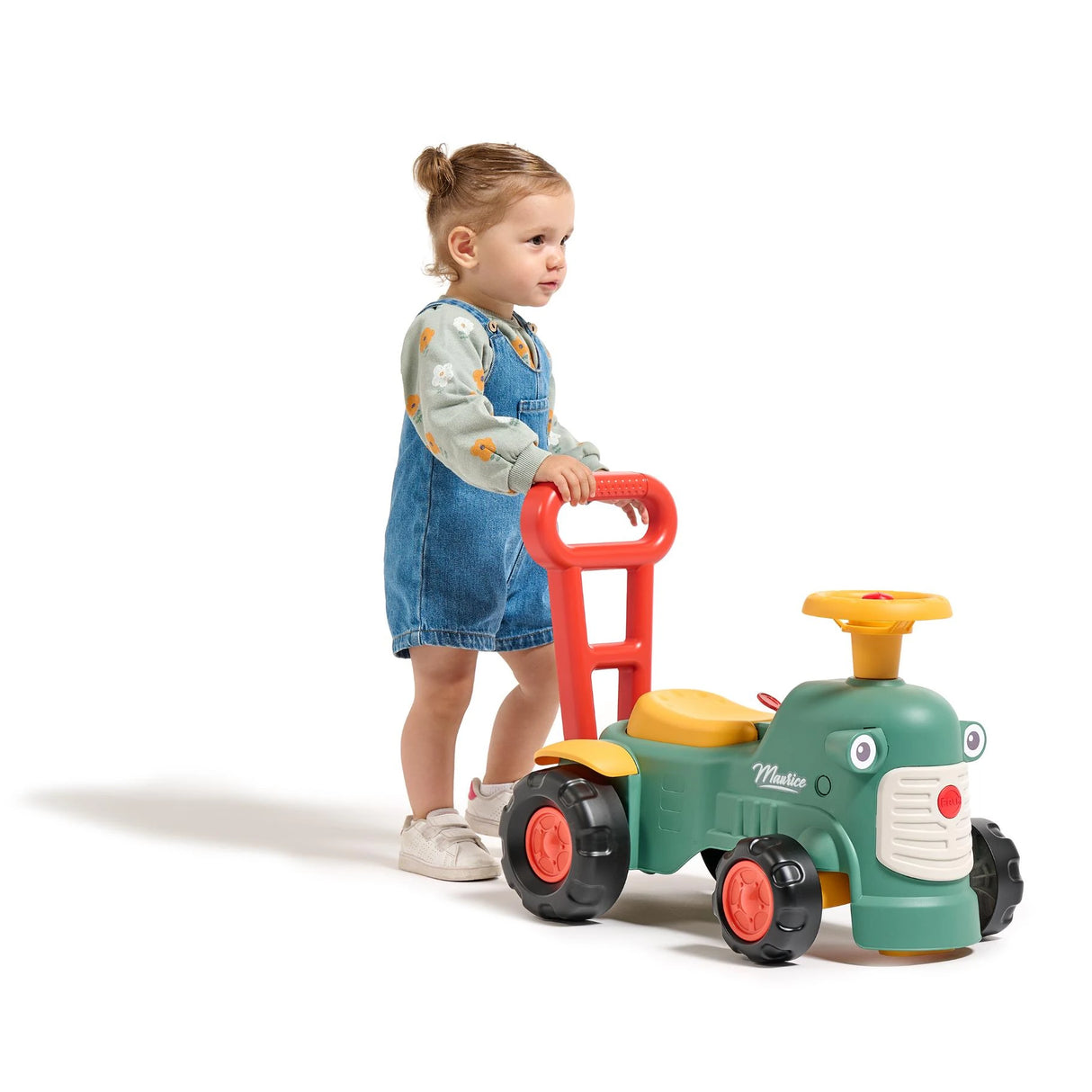 Child pushing Falk Maurice Vintage Baby Green Tractor with walking aid handle