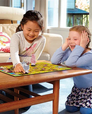 Two children playing Snakes & Ladders Farm Edition together at a table in Ireland