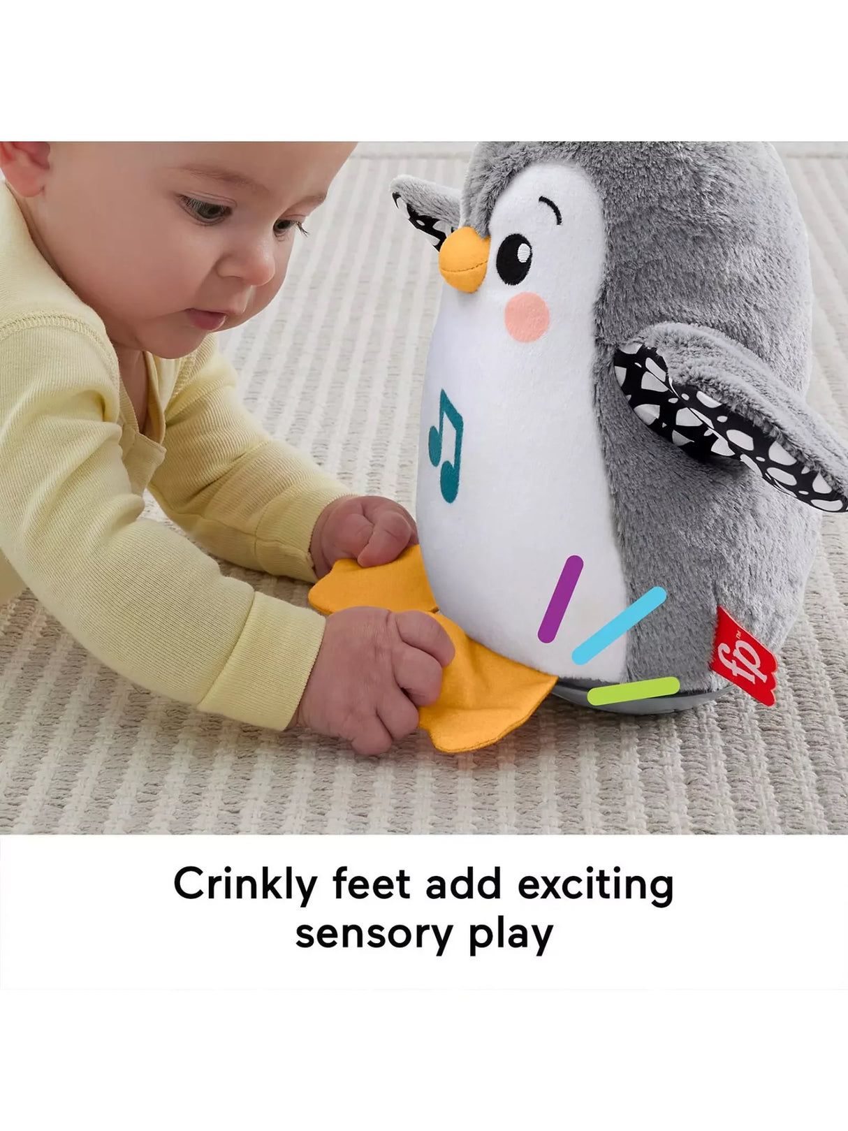 Baby interacting with Fisher Price Flap & Wobble Penguin during sensory play with music and motion