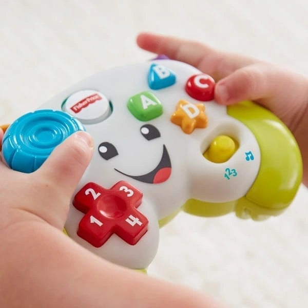 Hands holding the Fisher-Price Laugh & Learn Game & Learn Controller toy