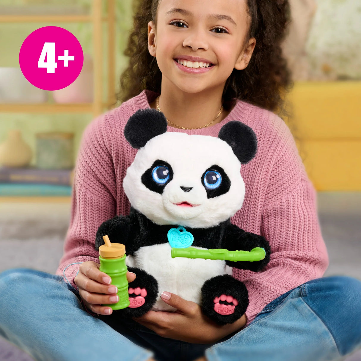 Child playing with FurReal Coco the Tumbling Panda plush toy in Ireland