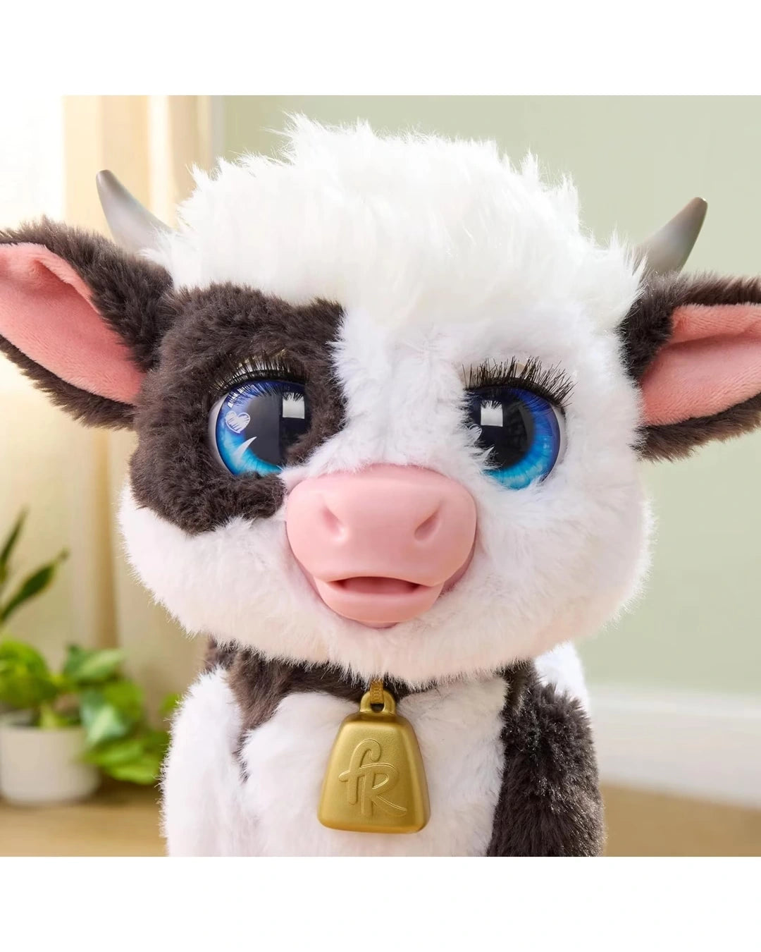 FurReal Riley the Feed & Follow Cow close up showing blue eyes, pink nose and gold bell
