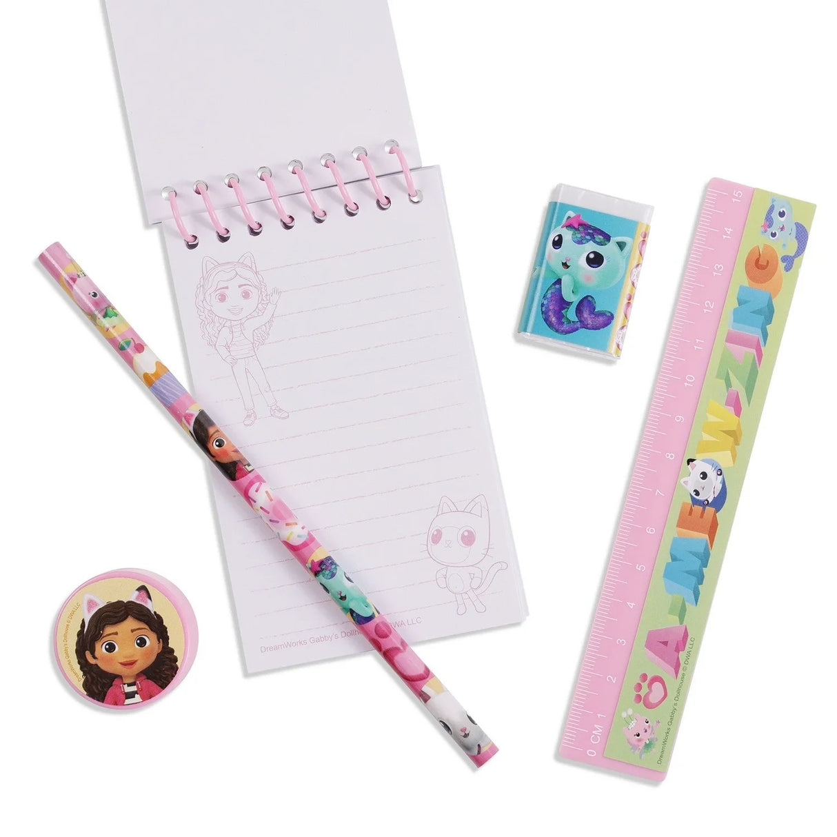 Gabby's Dollhouse stationery set with the spiral notebook open beside the pencil, ruler, eraser and sharpener
