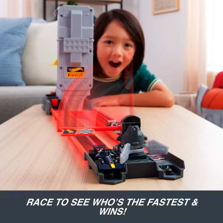 Child racing cars on the Hot Wheels F1 Race Starter Track Set