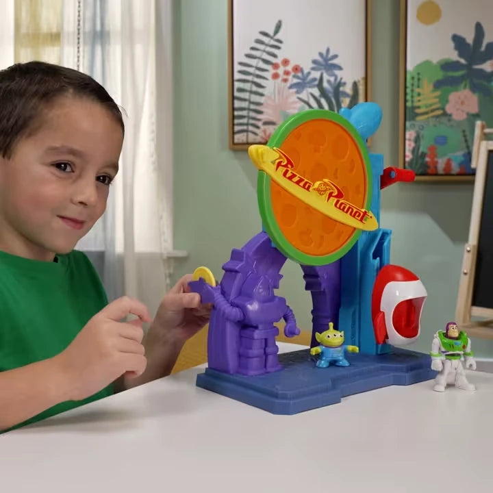 Child playing with the Imaginext Disney Pixar Toy Story Pizza Planet Playset with Buzz Lightyear and Alien figures