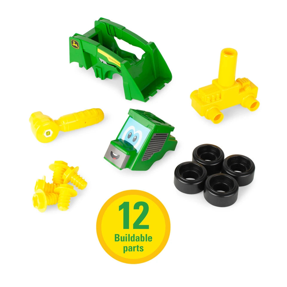 John Deere Build A Buddy skid steer parts laid out with yellow ratchet tool, yellow screws, four black tyres, green loader frame, green cab piece and yellow base, with “12 Buildable parts” badge