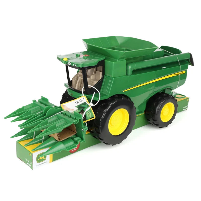 John Deere Lights & Sounds Combine 47714 front left view secured to the retail packaging with corn head fitted